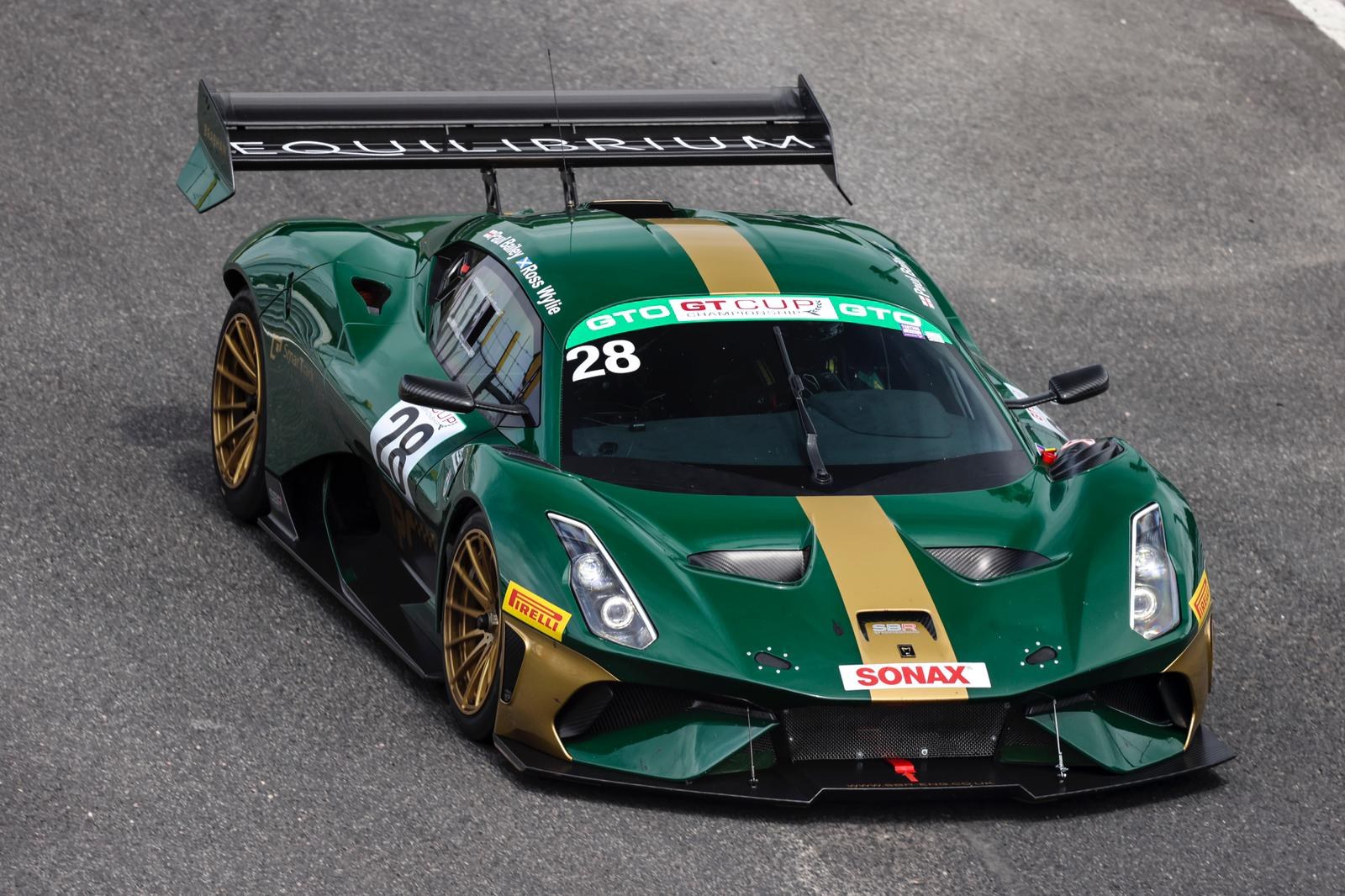 The British racing green and gold Brabham BT62, number 28, run by SBR, on track at Silverstone